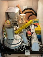 Group view of all appliances, wraps, trivets and accessories on shelf