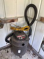 Full view of Craftsman wet/dry vacuum showing hose and extension cord
