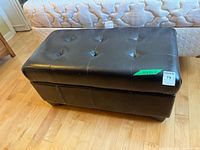 Closed ottoman showing tufted top and exterior