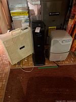 Group shot of Simplicity dehumidifier, Sears box fan, black tower purifier