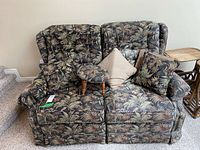 Front view of loveseat with pillows and footstool