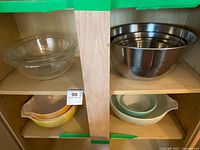 Cabinet shelves showing all bowl sets—glass, stainless and colored Pyrex—for overall context