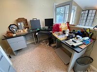 Overall view of three desk sections assembled in office setting