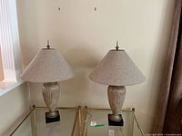 Both lamps side by side on glass tables