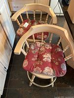 Both swivel bar stools side by side showing cushions, backs, and footrest rings