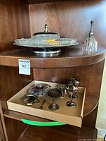 Overall view showing glass divided tray on silver base and box with silverplate pieces and goblets