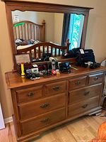 Front view of dresser with mirror showing overall design and hardware