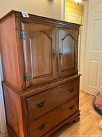 Front view of Vilas chest showing cabinet doors and lower drawer