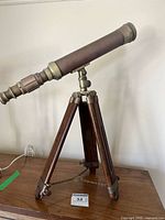 Side view of brass telescope on tripod
