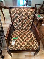 Front view of upholstered armchair showing fabric pattern and wooden frame