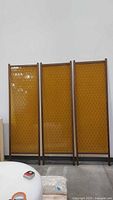 Full view of three amber divider panels standing upright