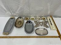 All items laid out: four trays, butterfly trivet, five coasters, boxed knife set