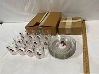 Overall view showing 12 cups, stack of 12 plates, and two storage boxes