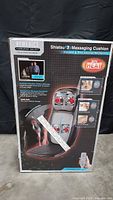 Box front showing HoMedics Therapist Select Shiatsu 1 Massaging Cushion with heat, product image, features, and scale ruler