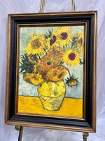 Full view of framed sunflower artwork on easel
