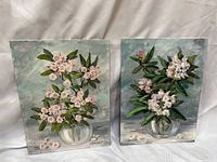 Front view of both floral paintings showing signatures