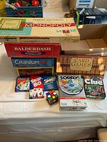 Stacked view showing Monopoly, Balderdash, Cranium, Wit's End, Card Games Gift Set, lower row of card games and Rubik's Cube