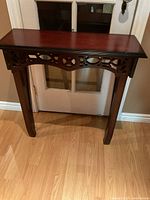 Front view showing table top, carved apron, overall style