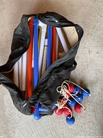 Bag opened showing pole sections and bolas