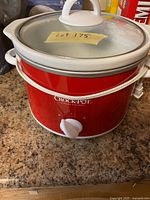 Front view Crock-Pot red slow cooker showing brand logo, knob and lid