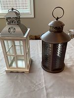 Front view of both decorative lanterns showing materials, colors, design and condition