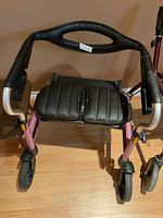 Top and side view of walker showing handles, brake levers, seat