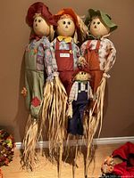 Full view of three large scarecrow stakes and one small scarecrow stake