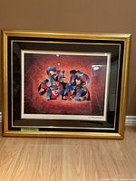 Full view of framed abstract artwork with gold frame