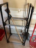 Overall view of plastic utility rack with fishing rod inside