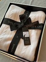 Boxed ivory cashmere throw with ribbon