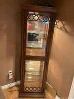 Full front view of wood and glass display cabinet