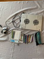 All items laid out: cooling pad, mouse, stylus pens, pouch