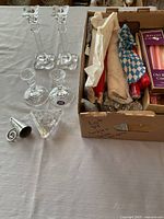 Two tall, one short candlestick, triangular holder, snuffer and box of assorted candles in cardboard tray