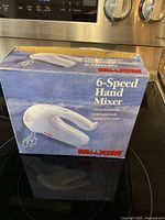 Retail box front showing Maxim 6-Speed Hand Mixer image and branding