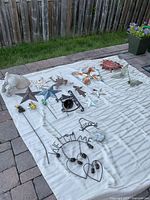 Full lot laid out on blanket showing all metal decor pieces