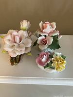 Front view of all three ceramic floral figurines