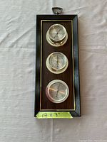 Full view of plaque showing three circular instruments