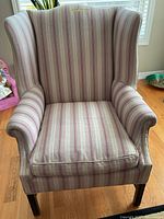 Front view of striped wingback armchair