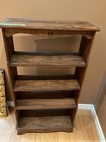 Front view showing shelves, drawer knobs, overall design