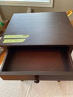 Table front view showing drawer closed and taped lot label