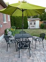 Entire patio set: four chairs, table, green umbrella