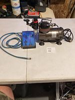 Compressor, hose and closed airbrush case