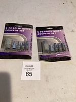 Two sealed 5-piece quick coupler sets side by side