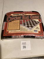 Front view of packaged checker rug game showing label