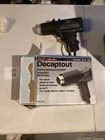 Heat gun resting on box showing overall lot