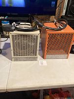 Both heaters side by side on table showing overall condition and cords