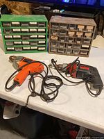 Overall lot view showing two organizer cabinets and two drills