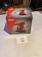 Front of Skil 1/4 sheet palm sander box showing product image