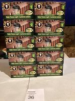 Stack of ten boxed Greenacres Solar Fence Light packages