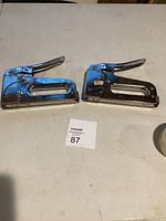 Overall view of two Arrow T50M staple guns on table